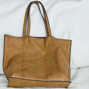 Vintaged Prada tote with embossed logo.